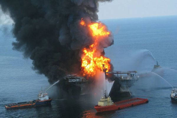 zoomed out deepwater horizon on fire boats spraying water on fire